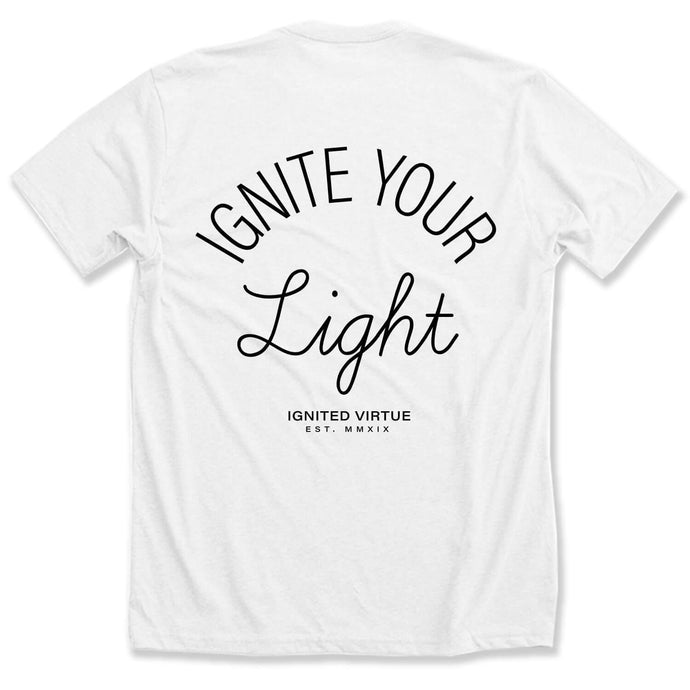 Graphic t-shirt with a small black lightning bolt on the front and the words ignite your light on the back on a white tee